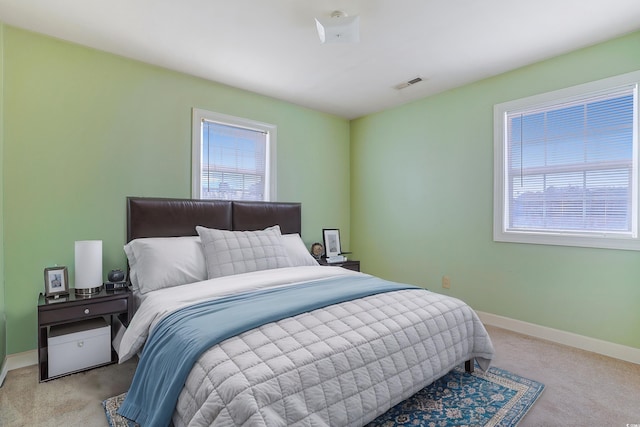 bedroom with light colored carpet