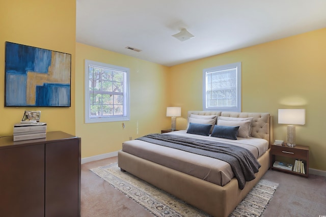 bedroom featuring light colored carpet