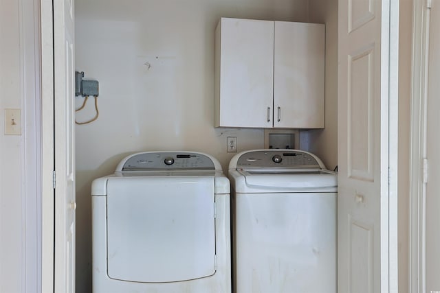 washroom with cabinets and independent washer and dryer