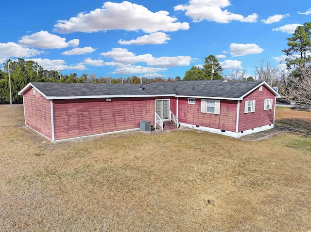 view of front of property with a front yard and central air condition unit