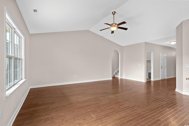 empty room with ceiling fan, dark wood-type flooring, and vaulted ceiling