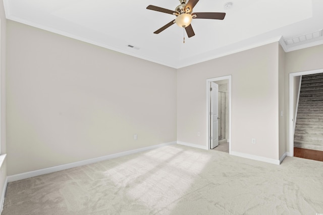 unfurnished bedroom with connected bathroom, ceiling fan, light colored carpet, and ornamental molding