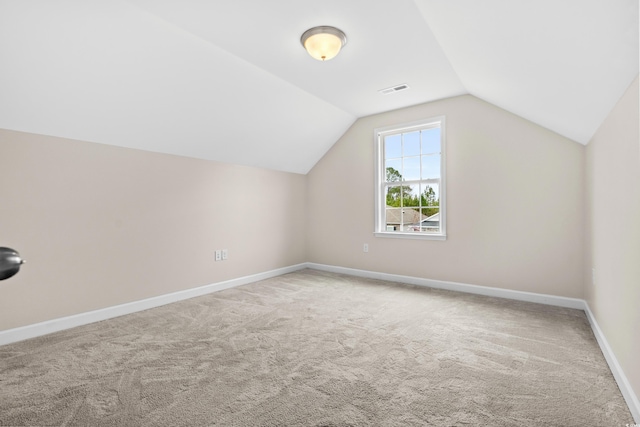 bonus room with carpet flooring and lofted ceiling