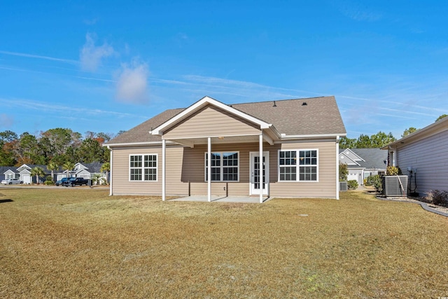 back of property with a yard, a patio, and central AC unit