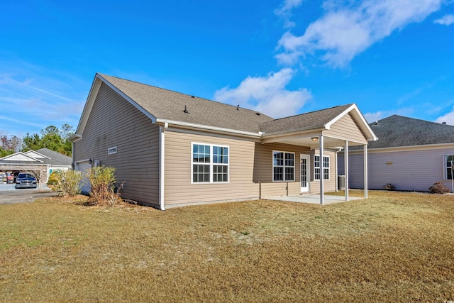 back of property featuring a patio and a lawn