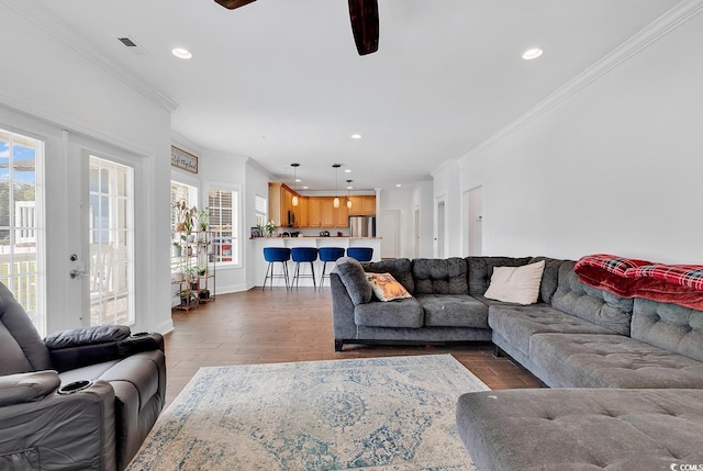 living room with ceiling fan, dark hardwood / wood-style flooring, and crown molding