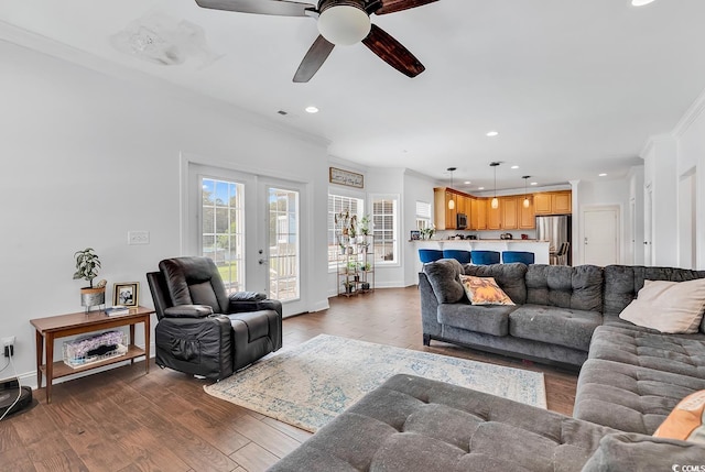 living room featuring french doors, dark hardwood / wood-style flooring, ceiling fan, and crown molding