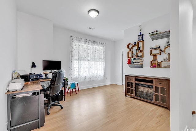 office space with light wood-type flooring