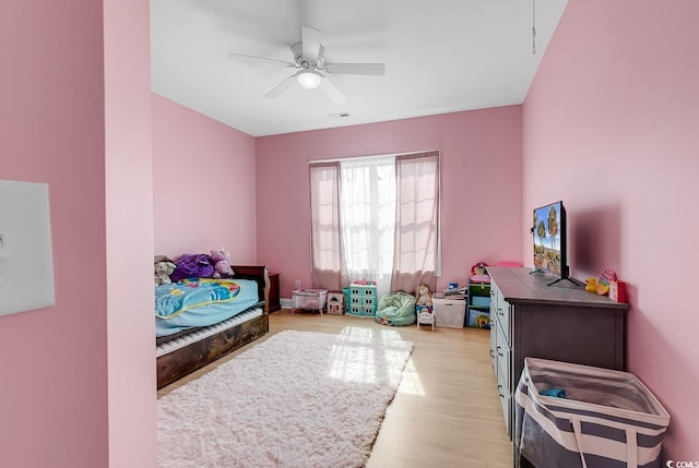 bedroom with ceiling fan and light wood-type flooring