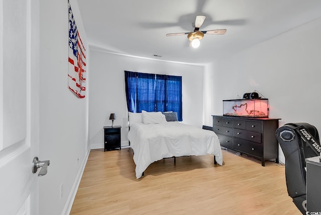 bedroom with ceiling fan and light hardwood / wood-style floors