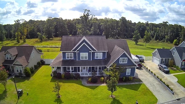 view of front of property featuring covered porch and a front lawn