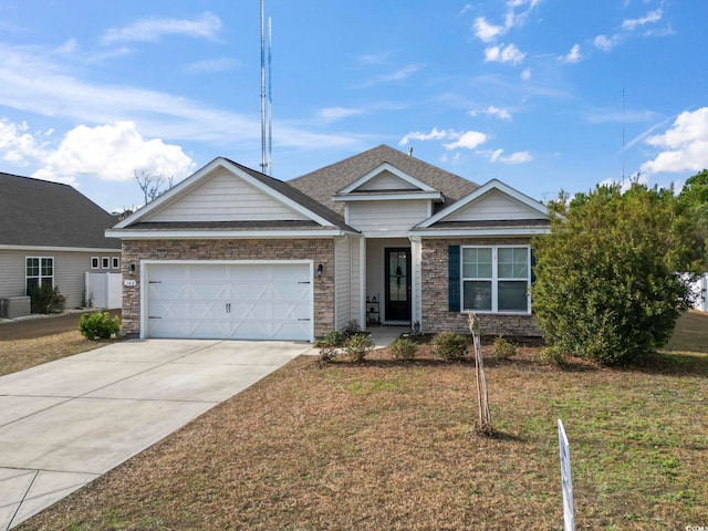 view of front of home with a front yard and a garage