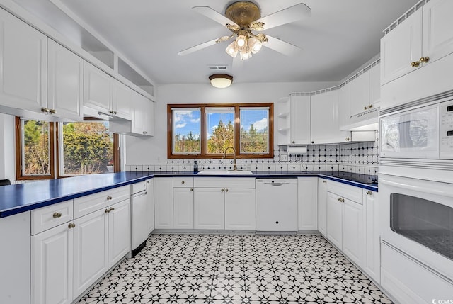 kitchen with sink, white appliances, decorative backsplash, and white cabinets