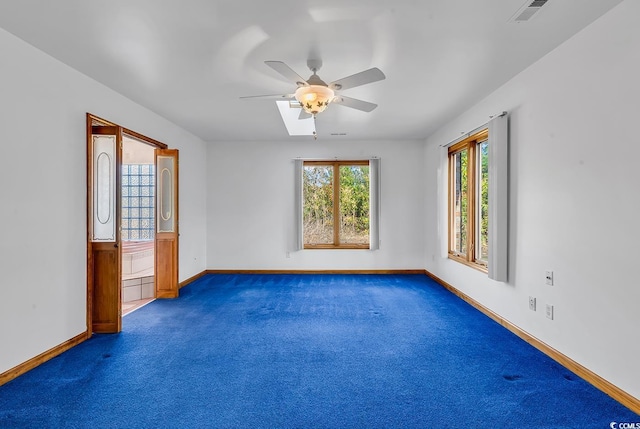 carpeted spare room featuring ceiling fan