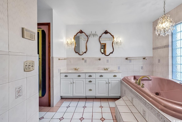 bathroom featuring vanity, tile walls, and tiled tub