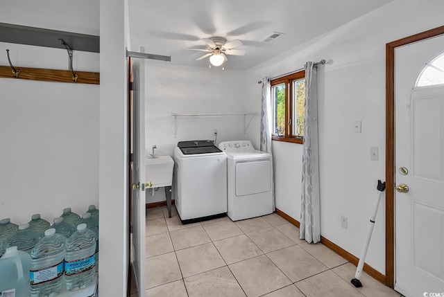 washroom with ceiling fan, light tile patterned floors, a wealth of natural light, and washing machine and clothes dryer