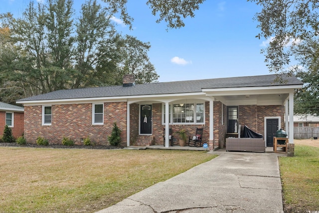 ranch-style house with a front yard and a porch