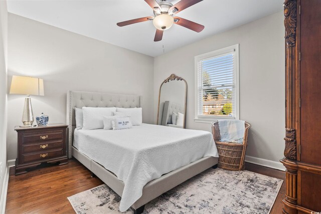 bedroom with ceiling fan and dark hardwood / wood-style flooring