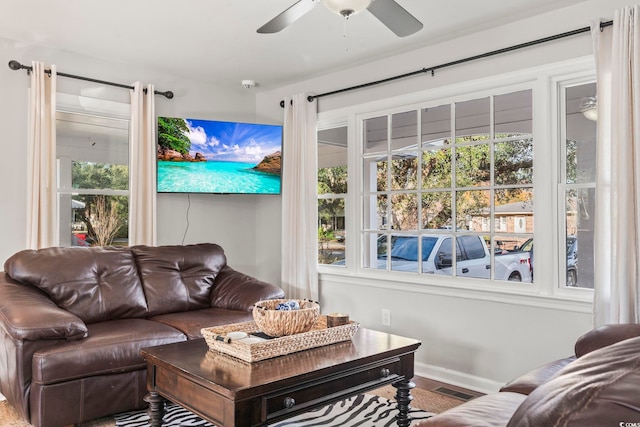 living room featuring hardwood / wood-style floors and ceiling fan