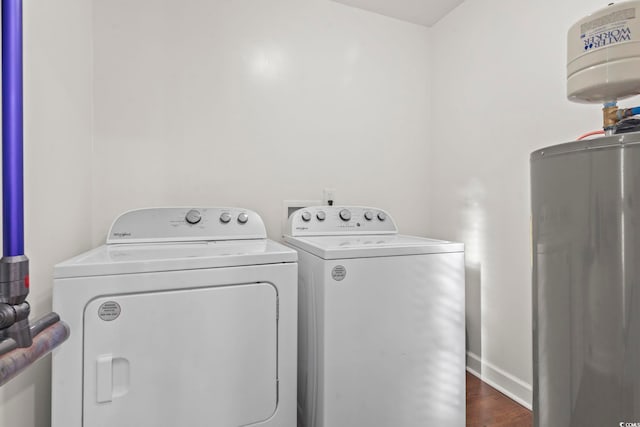 1673 Middleton St, Georgetown, SC 29440 - laundry room featuring washing machine and clothes dryer, water heater, dark wood-style flooring, and baseboards