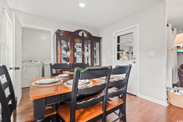 dining room featuring light hardwood / wood-style flooring and washing machine and dryer