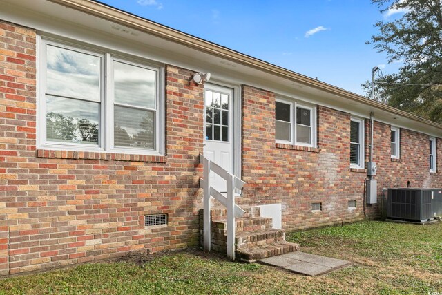 exterior space featuring a yard and cooling unit