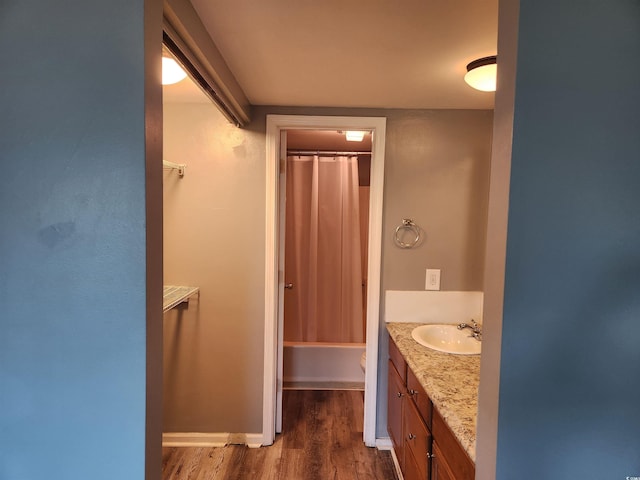 full bathroom with shower / bathtub combination with curtain, toilet, vanity, and hardwood / wood-style flooring