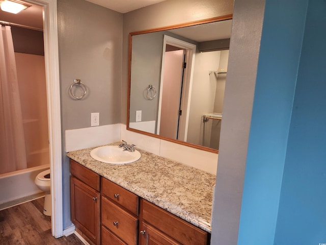 full bathroom featuring toilet, vanity, shower / bath combination with curtain, and hardwood / wood-style flooring