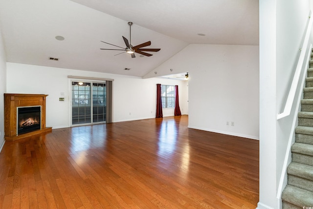 unfurnished living room with hardwood / wood-style floors, a wealth of natural light, and ceiling fan