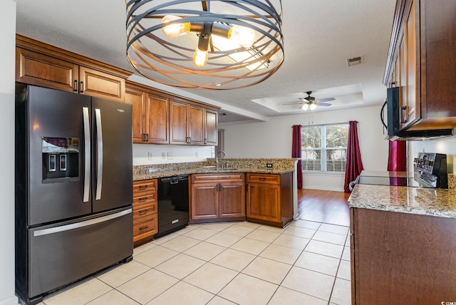 kitchen featuring stone counters, a textured ceiling, ceiling fan, and black appliances