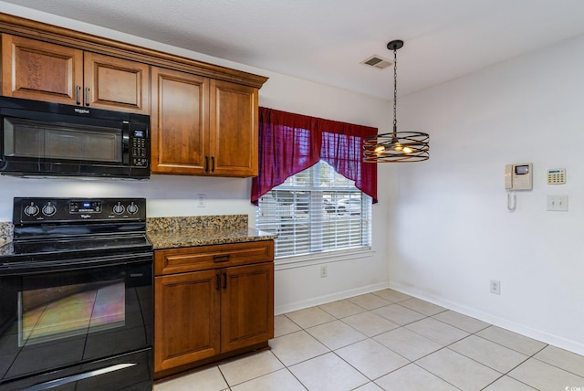 kitchen with black appliances, dark stone countertops, decorative light fixtures, light tile patterned flooring, and a chandelier