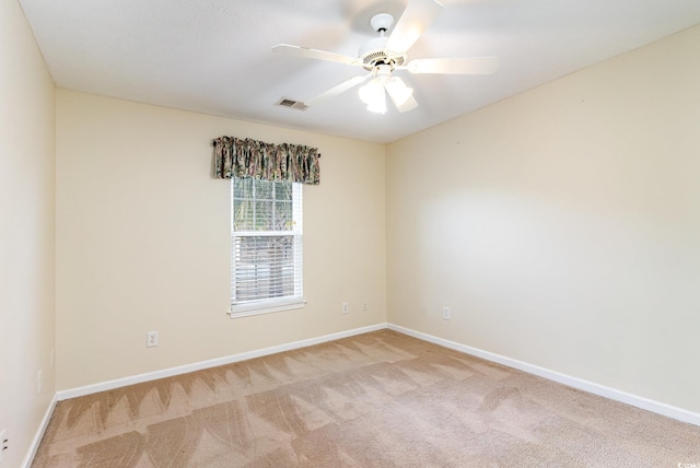 carpeted spare room featuring ceiling fan