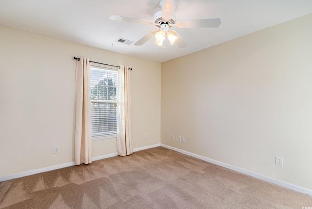 unfurnished room featuring ceiling fan and light carpet