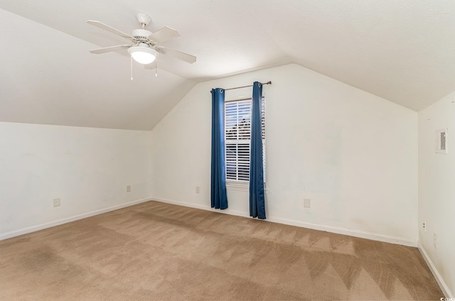 bonus room with ceiling fan, light colored carpet, and vaulted ceiling