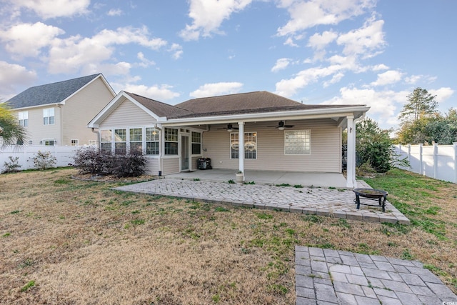 back of house featuring ceiling fan, a yard, and a patio