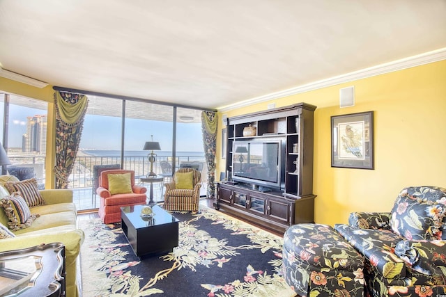 living room with hardwood / wood-style flooring, a wall of windows, and crown molding