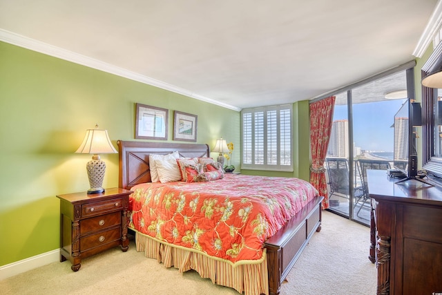 bedroom with light colored carpet, crown molding, and access to outside