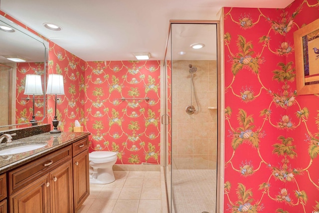 bathroom featuring tile patterned flooring, vanity, an enclosed shower, and toilet