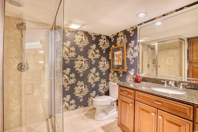 bathroom with toilet, vanity, tile patterned floors, and a shower with shower door