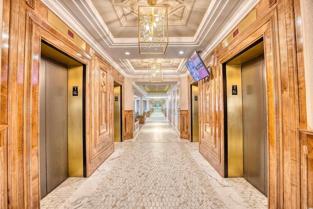 corridor with a raised ceiling, elevator, and crown molding