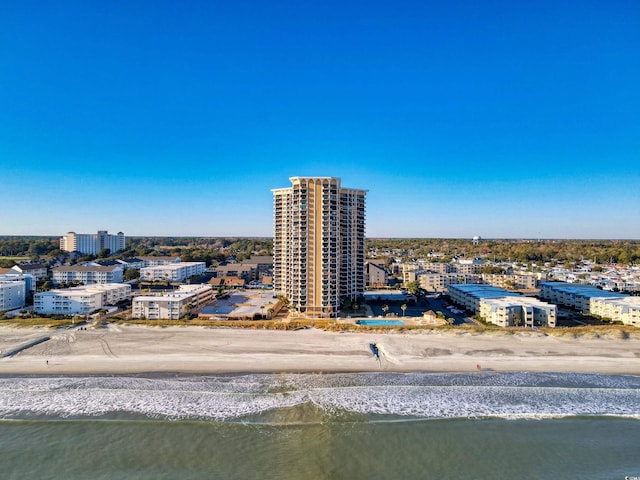 drone / aerial view with a water view and a view of the beach