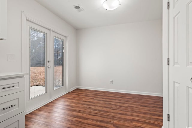 unfurnished room featuring french doors and dark hardwood / wood-style floors