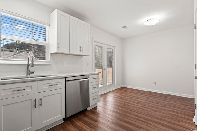 kitchen with sink, white cabinets, stainless steel dishwasher, and plenty of natural light