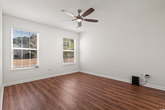 spare room with ceiling fan and dark wood-type flooring