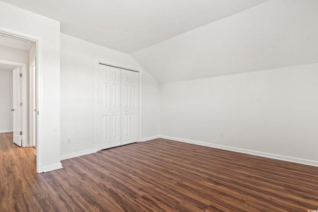 additional living space featuring dark hardwood / wood-style flooring and vaulted ceiling