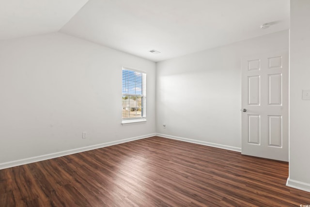 unfurnished room with dark hardwood / wood-style floors and lofted ceiling