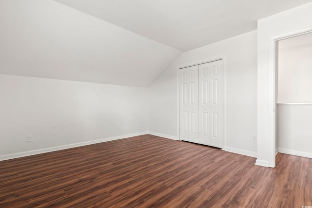 bonus room with lofted ceiling and dark wood-type flooring