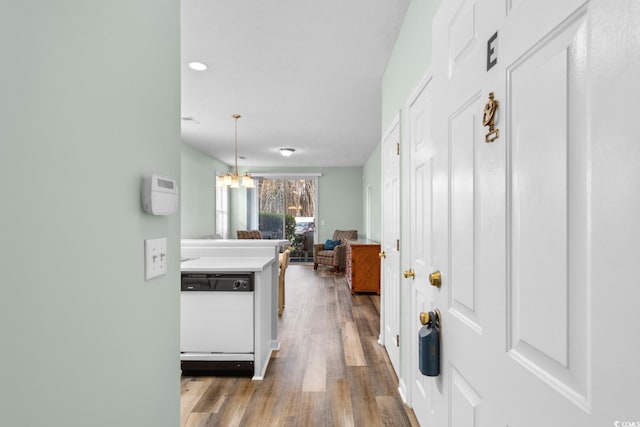 interior space featuring hardwood / wood-style flooring and an inviting chandelier