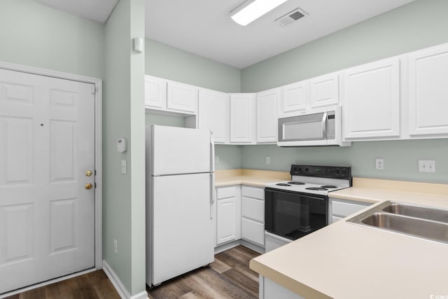 kitchen featuring white cabinets, dark hardwood / wood-style flooring, white appliances, and sink