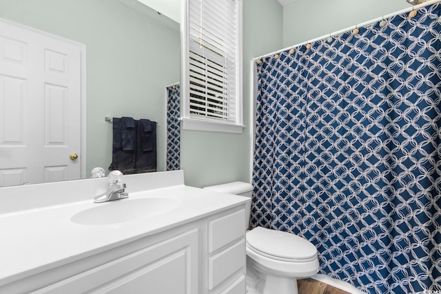 bathroom with vanity, a shower with shower curtain, and toilet